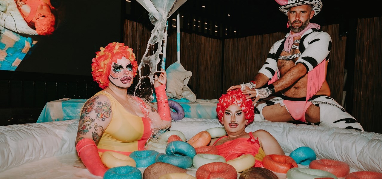 Three Performers (two as synchronised swimmers and one as a cow), posing around a human sized cereal bowl.