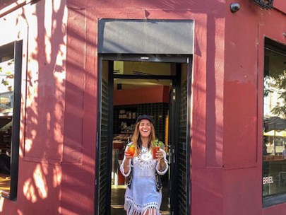 Photo of a happy person in front of the Gabriel cafe