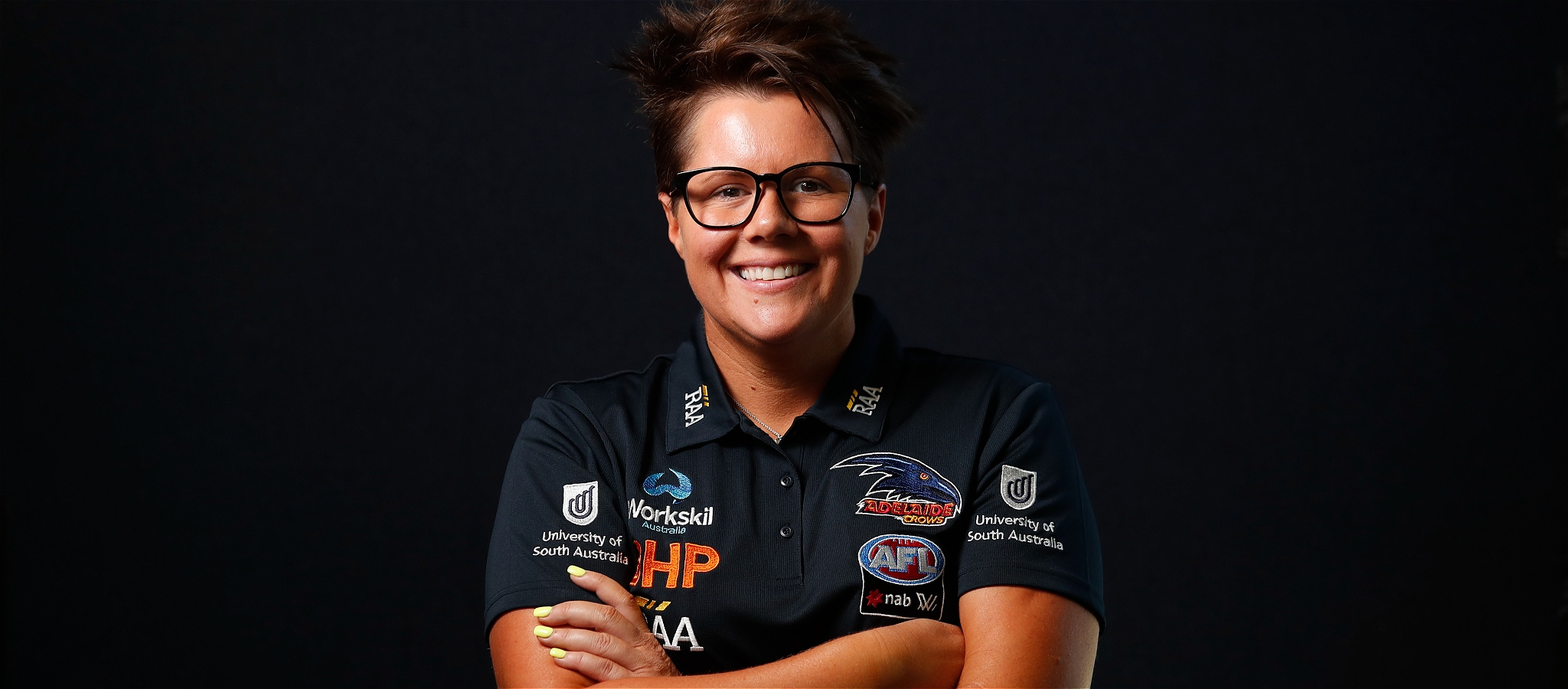 A person looking very self-assured dressed in black against a black background