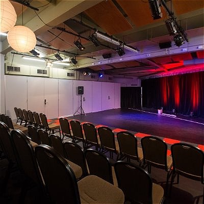 Interior of the Studio space showing non-raked seating and a large, flat stage area