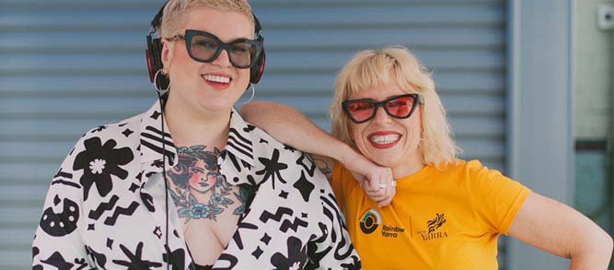 Two people together smiling behind the DJ booth.