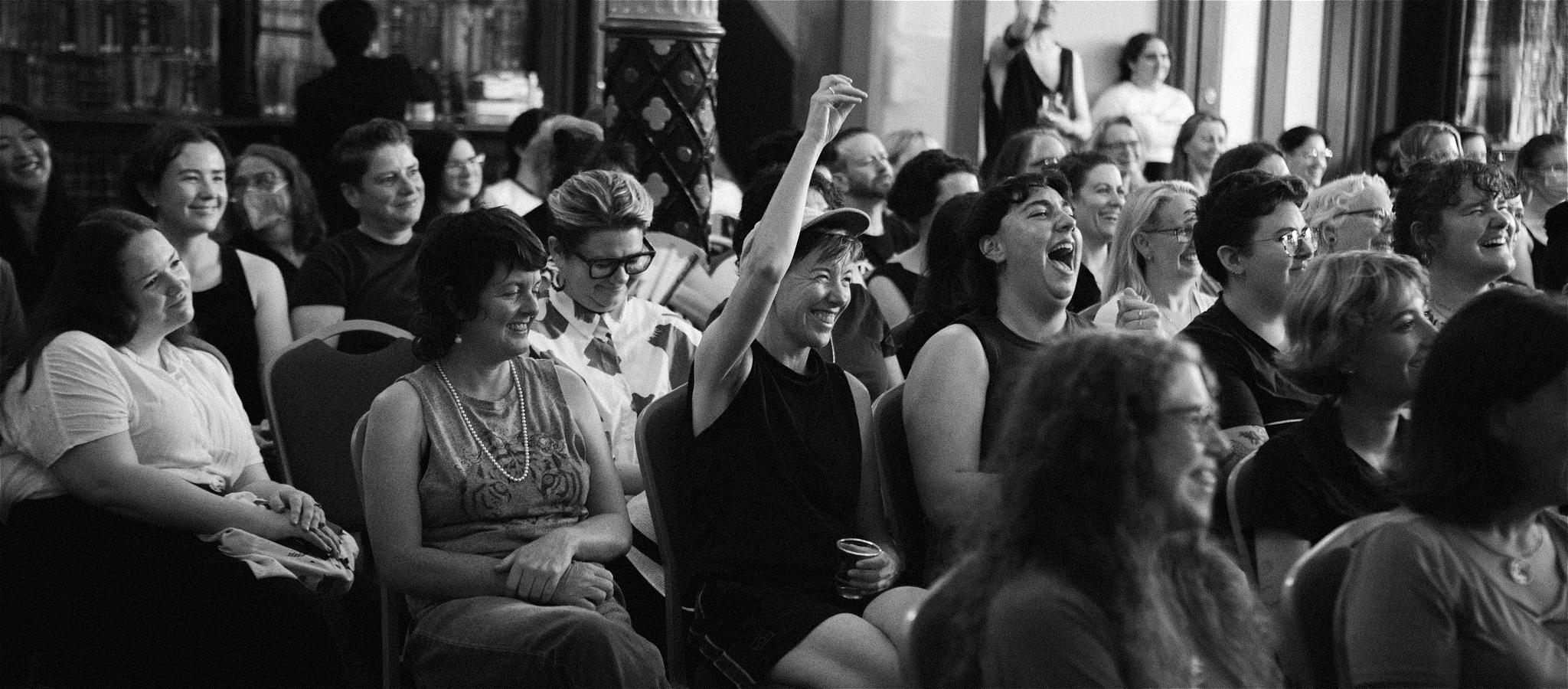 Audience members watching and cheering the performance.