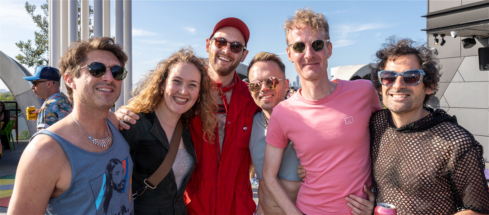 A photo of a group of people wearing sunglasses and smiling into the camera