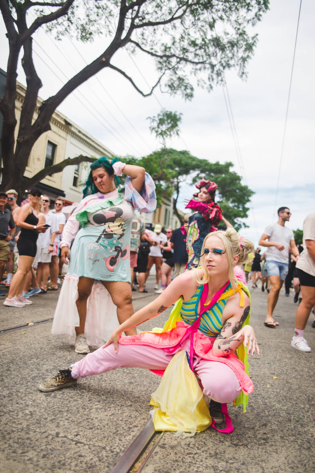 Three people dressed in "interesting" costumes, posing on the Gertrude Street tram tracks