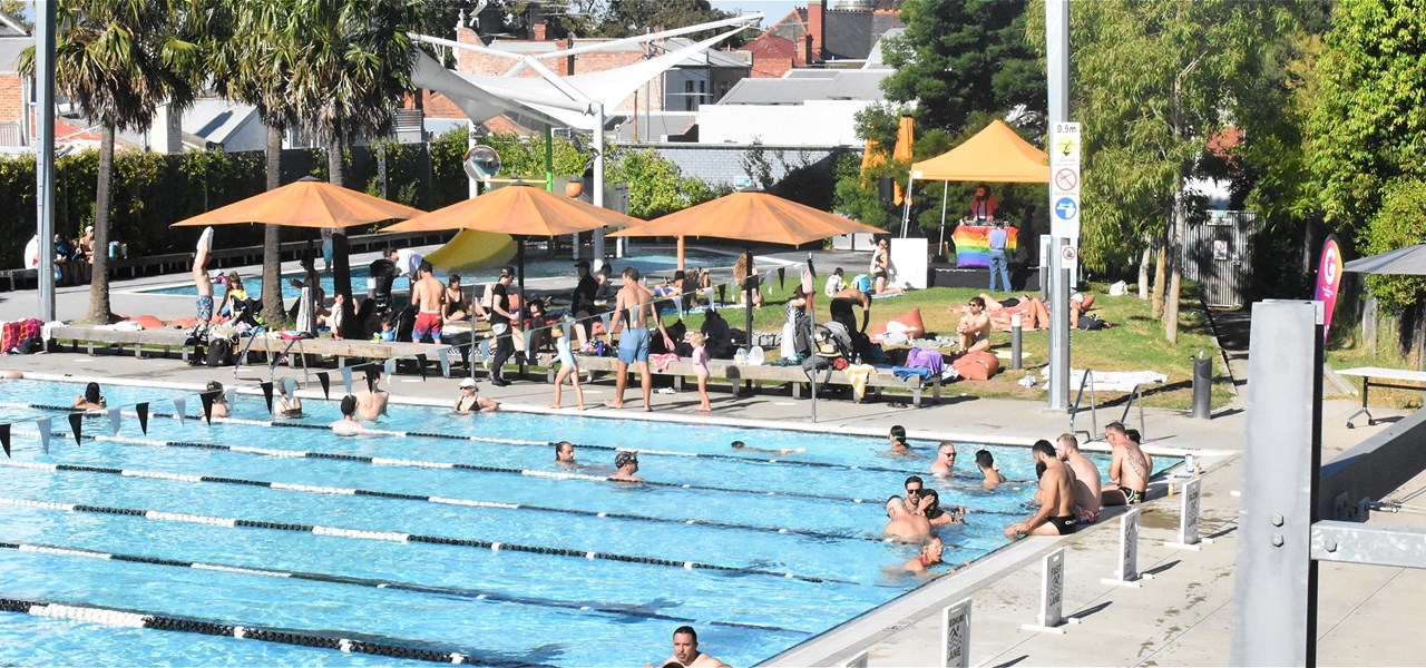A birds eye view of a warm summers day with people in and around the Carlton Pool.