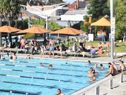 A birds eye view of a warm summers day with people in and around the Carlton Pool.