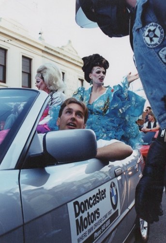 Lee Mathews in a BMW at Pride March with Gina Riley and Jane Turner in the back