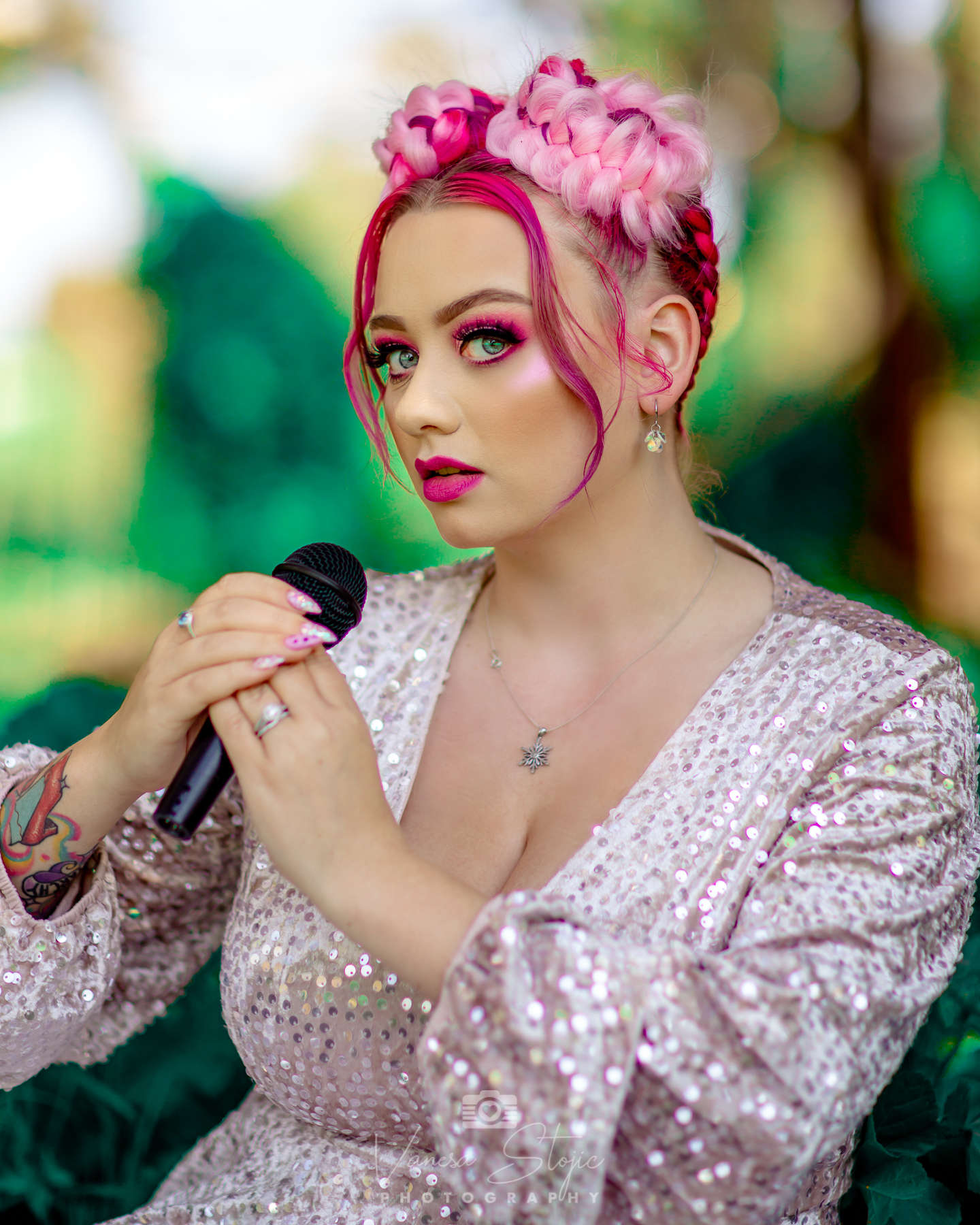 Elegantly dress woman holding a microphone, looking wistfully into the camera