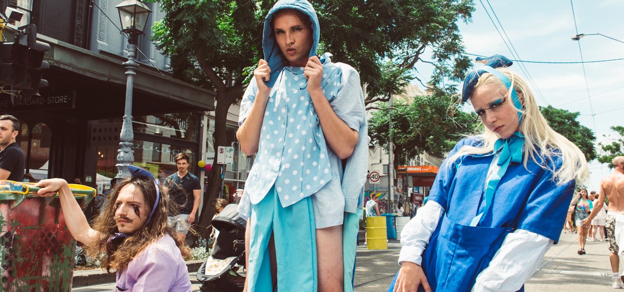 Three people dressed "unusually", posing in Gertrude Street during Melbourne Pride 2022