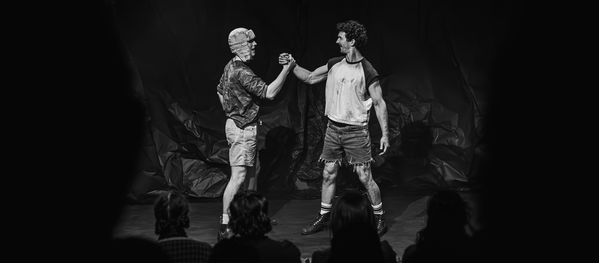 Two friends high five on a trip, they look optimistic and friendly.