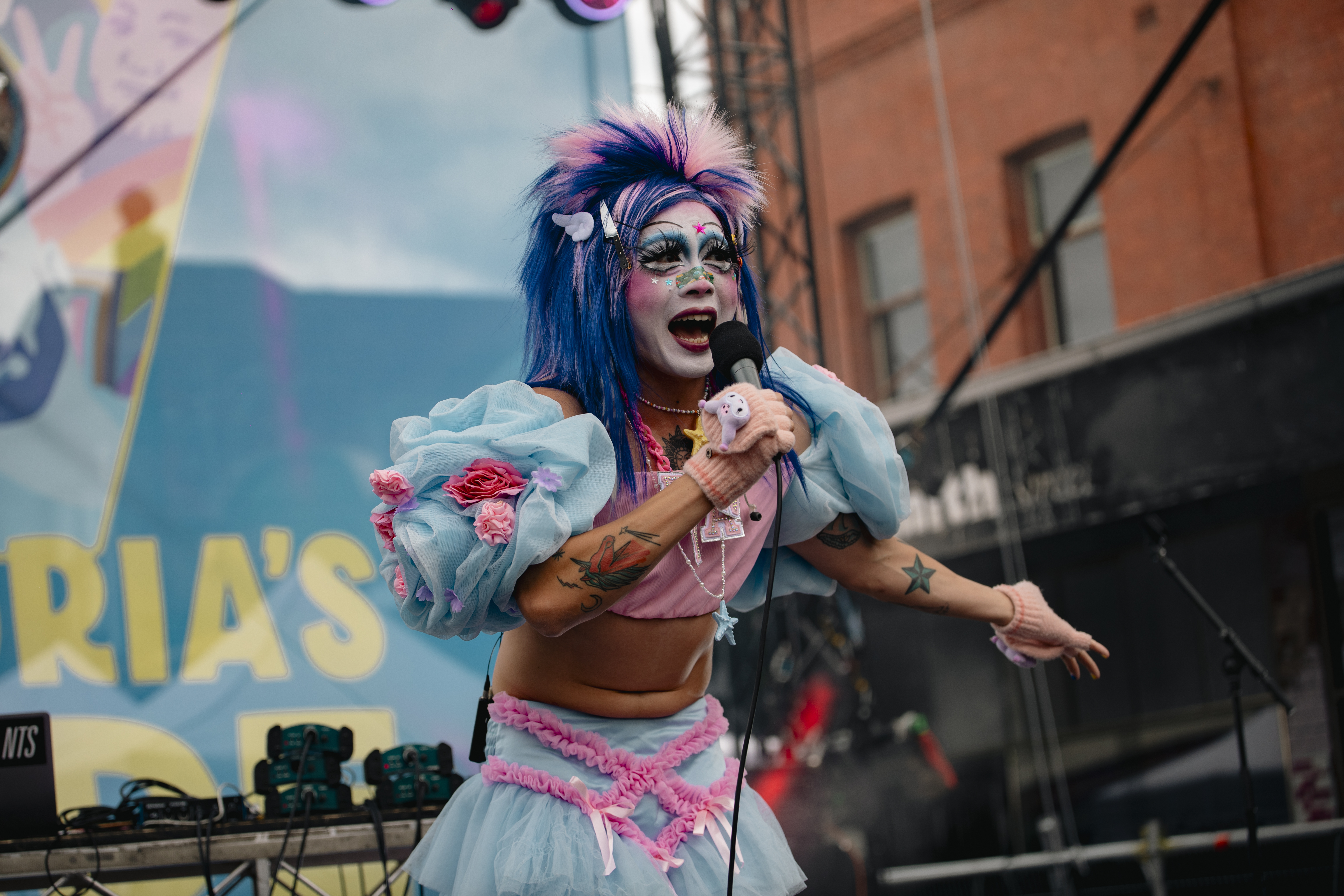 Performer with microphone at Victoria's Pride Street Party