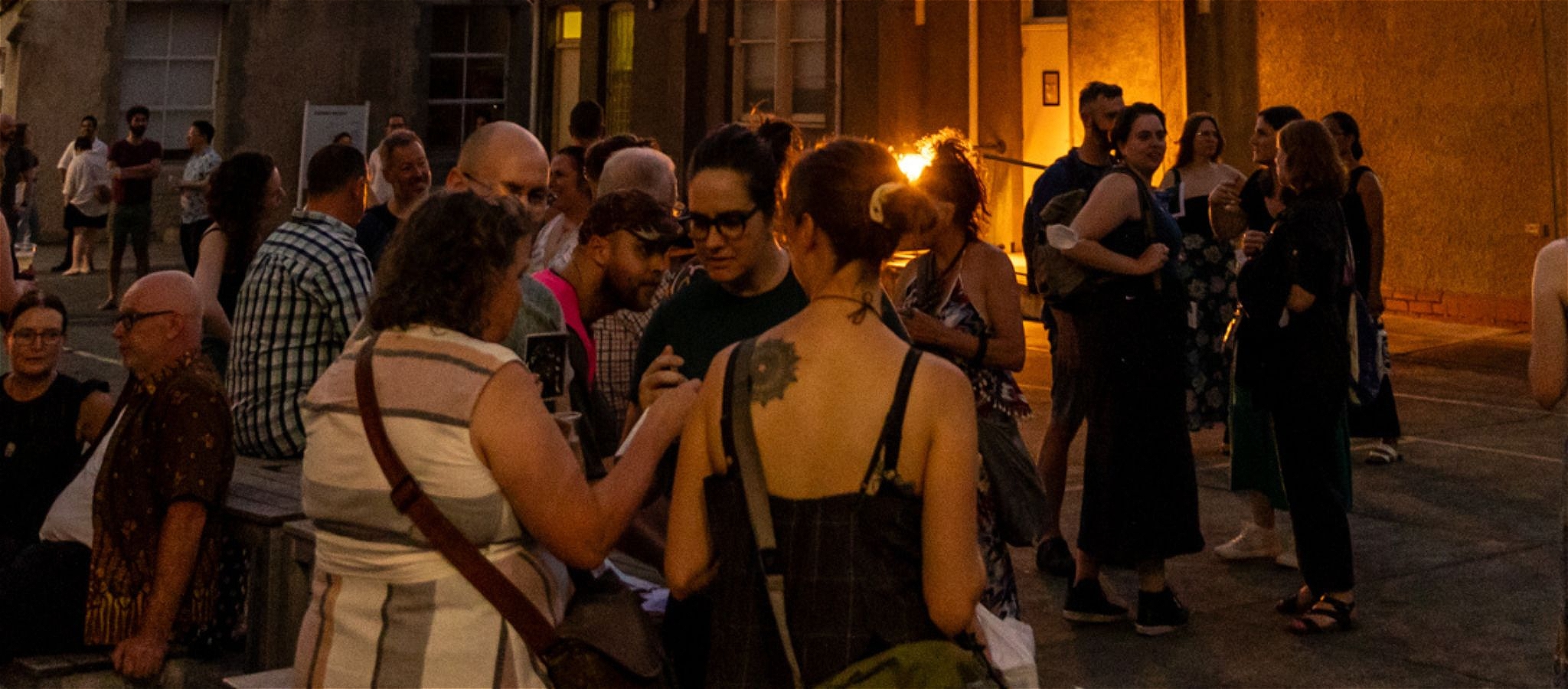 Image of a group of people networking and interacting at an outdoor event