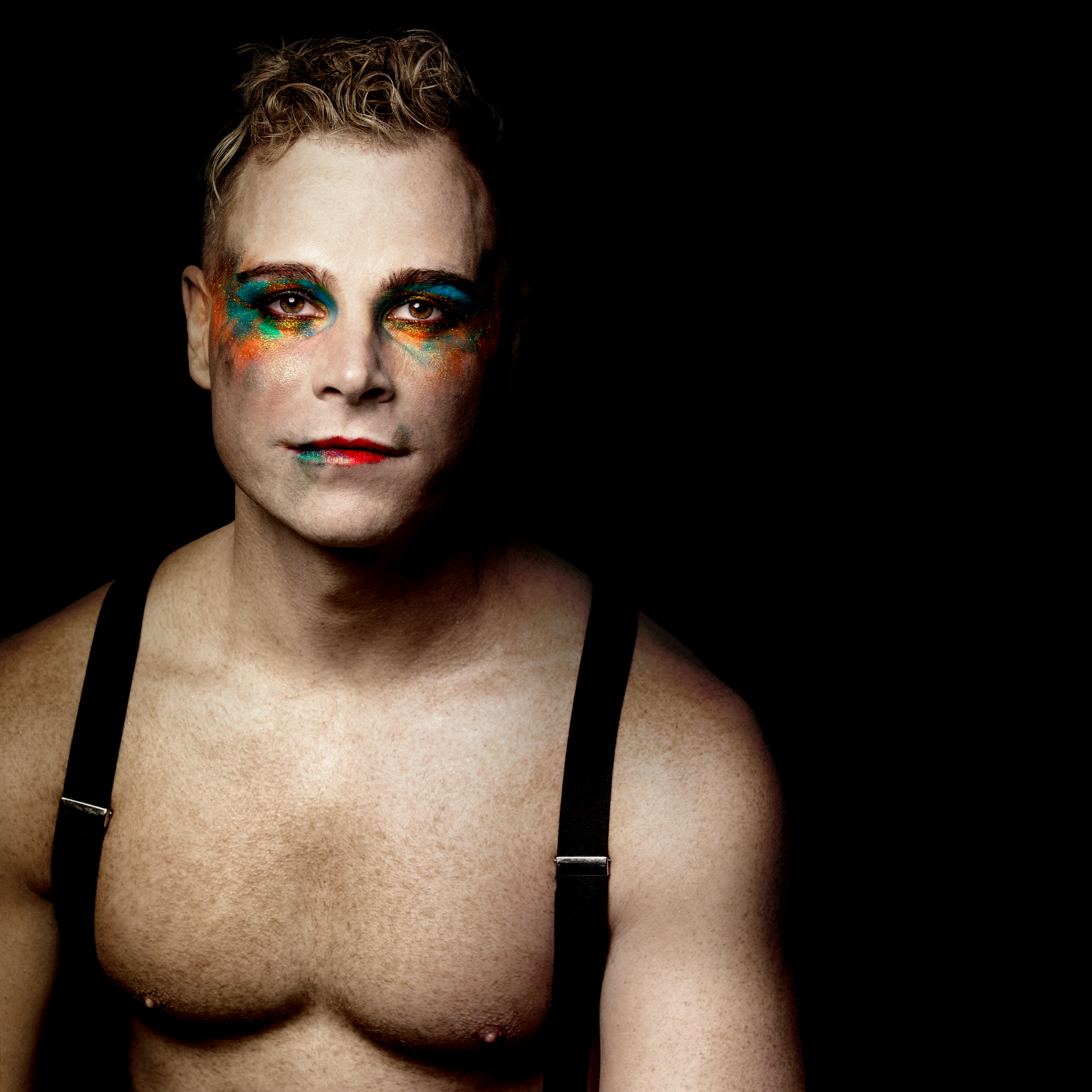 Vincent Hooper bare-chested though with straps passing over his shoulders