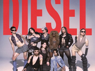 House of Diesel group posing in front of a massive DIESEL sign