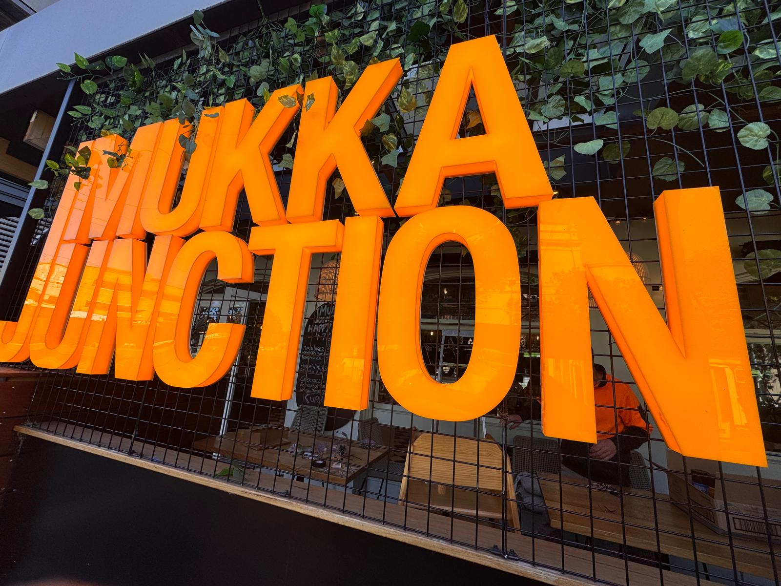 Photo of the exterior sign of Mukka Junction - the large sign says Mukka Junction
