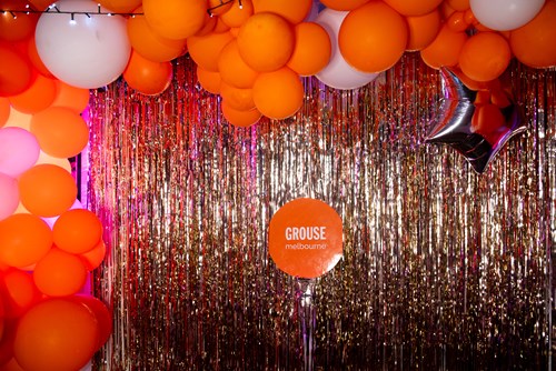 Interior of the Grouse venue with a curtain of silver ribbons and lots of balloons