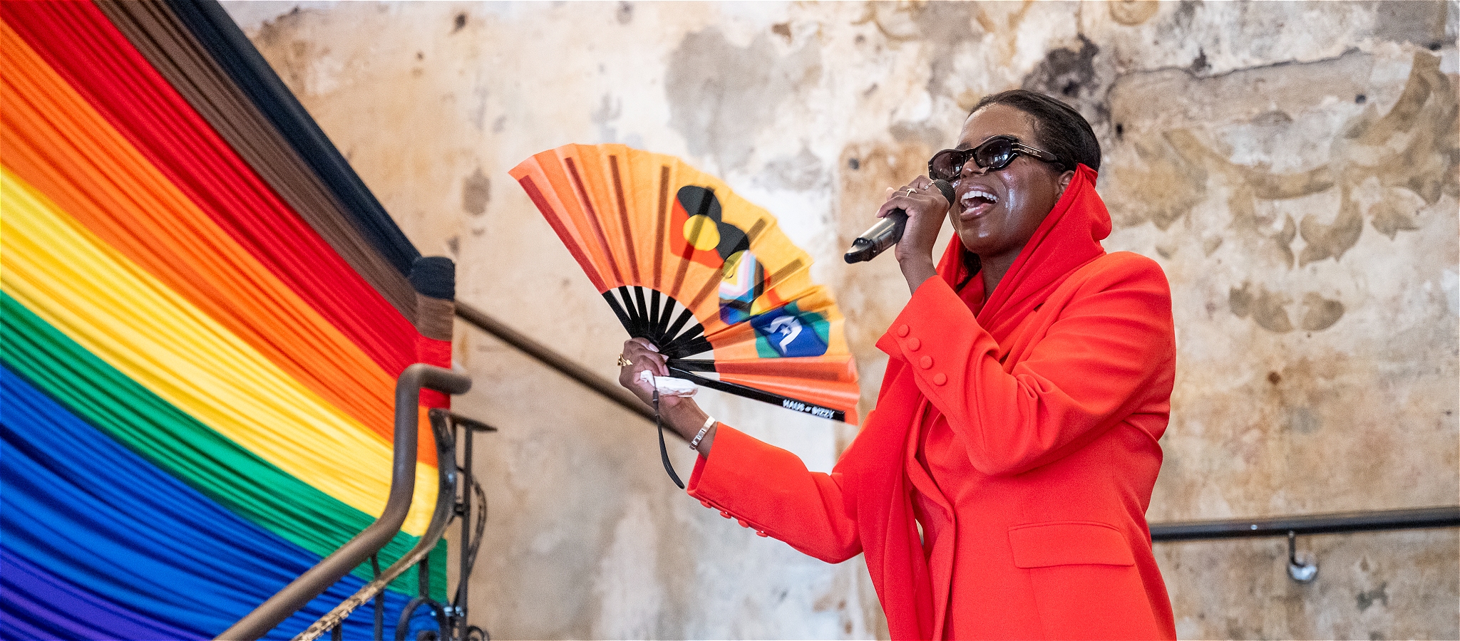 Performer holding fan and singing