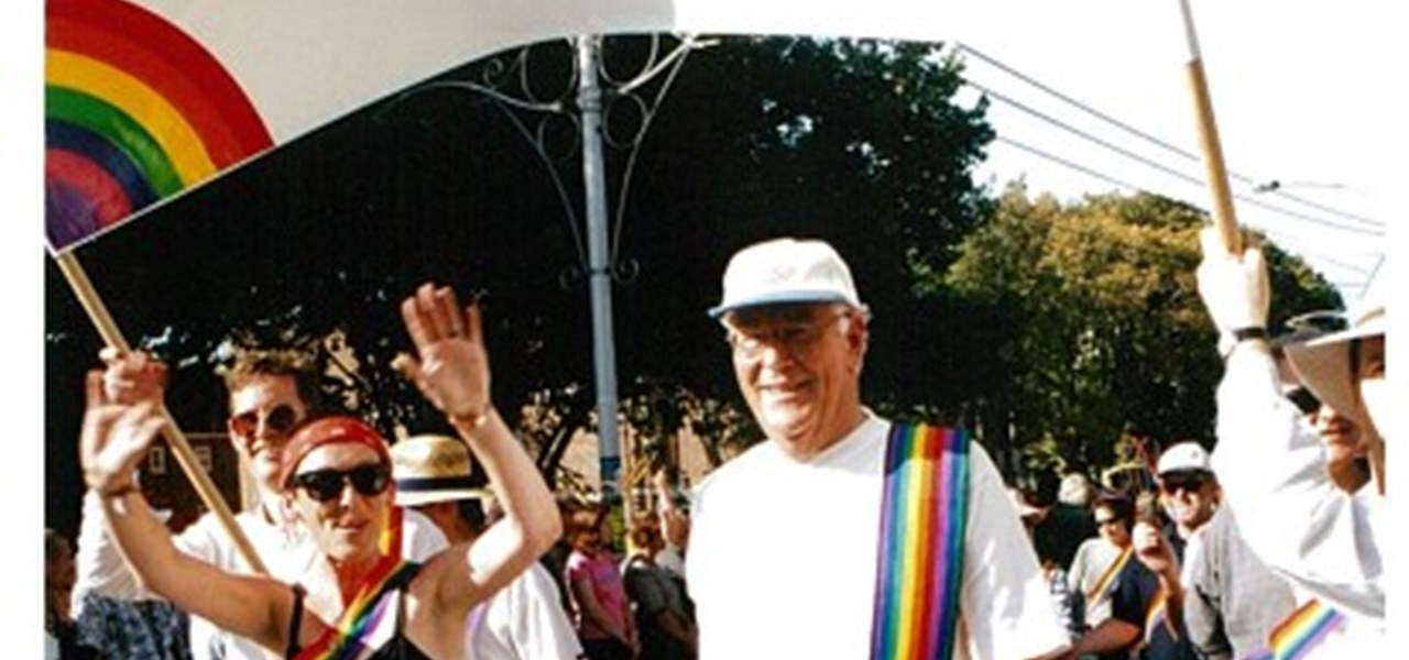 Pride March 2000 image: marchers under a banner: "The Rainbow Sash"