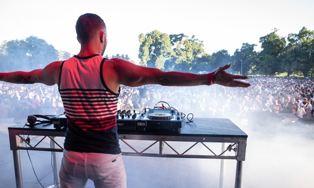 DJ with arms outstretched before a large crowd at Midsumma Carnival 2019