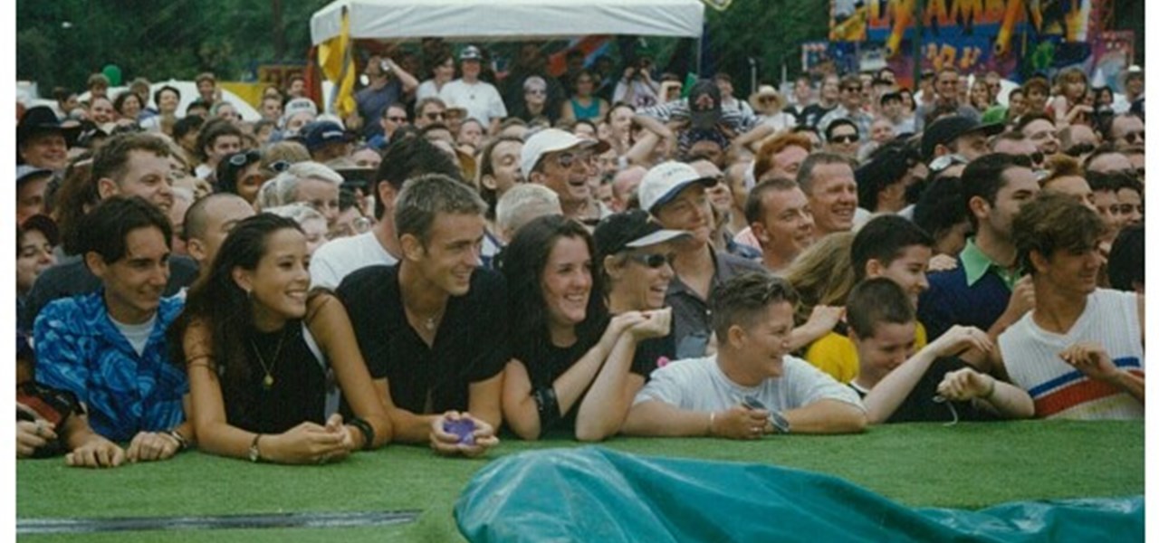 Midsumma Carnival 1996 by Richard Israel and 1997 by Virginia Selleck: an audience looking on, with the front people leaning on the artificial turf covered catwalk