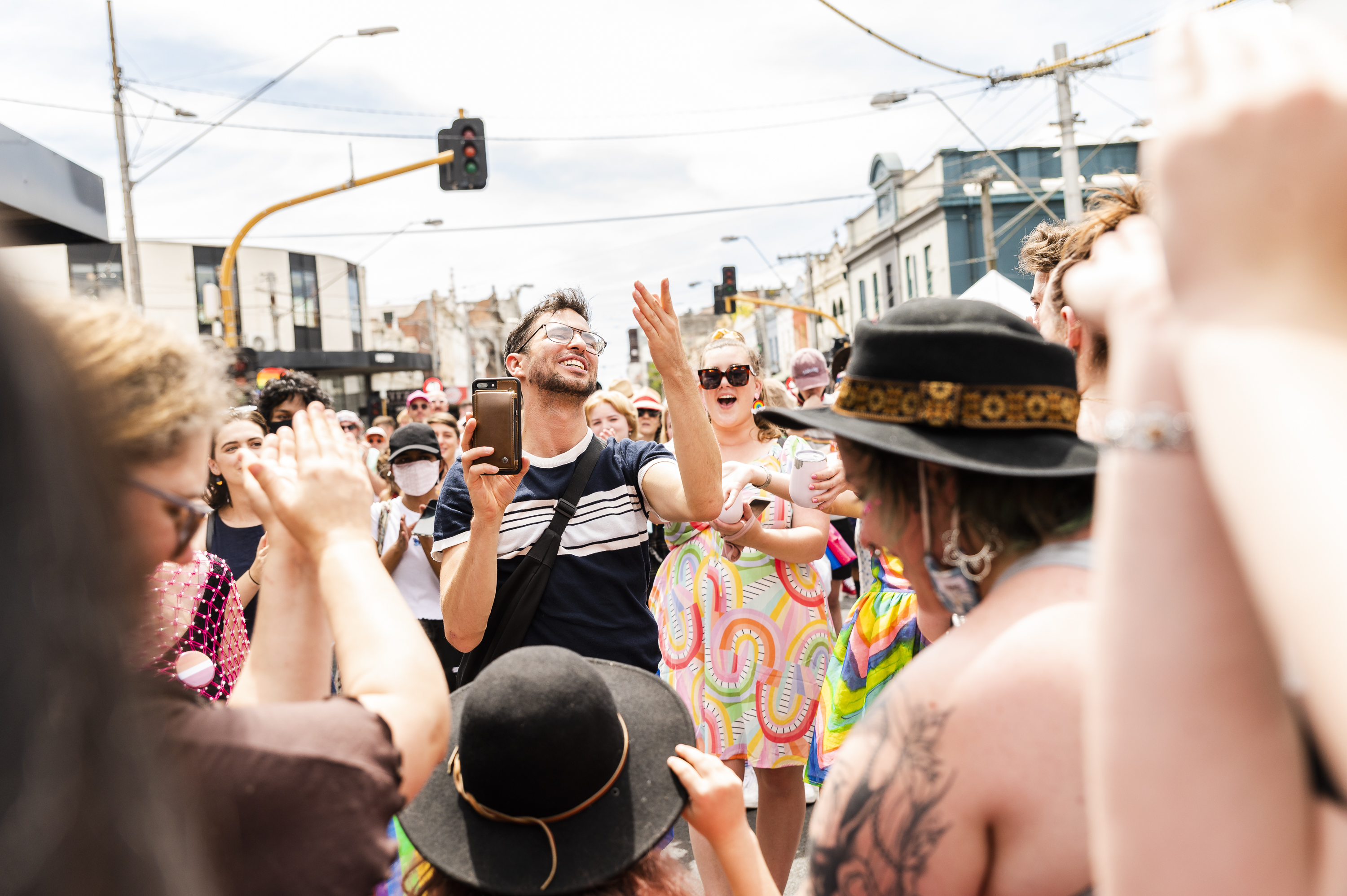 People dancing happily in the street at Melbourne Pride in 2022