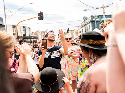 People dancing happily in the street at Melbourne Pride in 2022