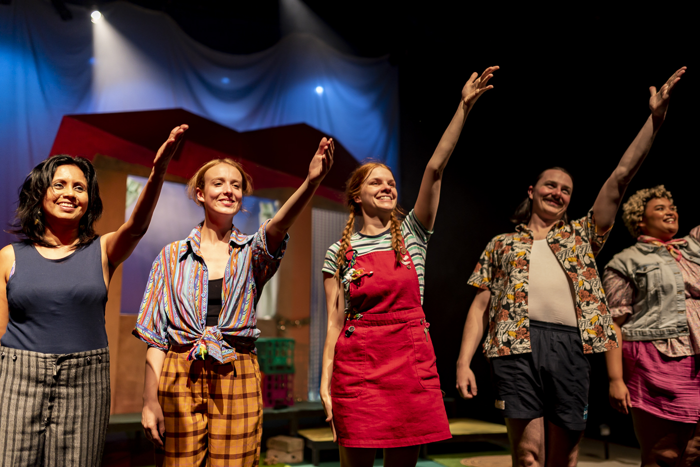 The cast hold their hands to the audience to say thank you