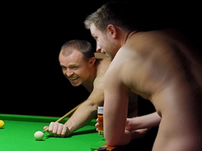 Two naked men playing billiards