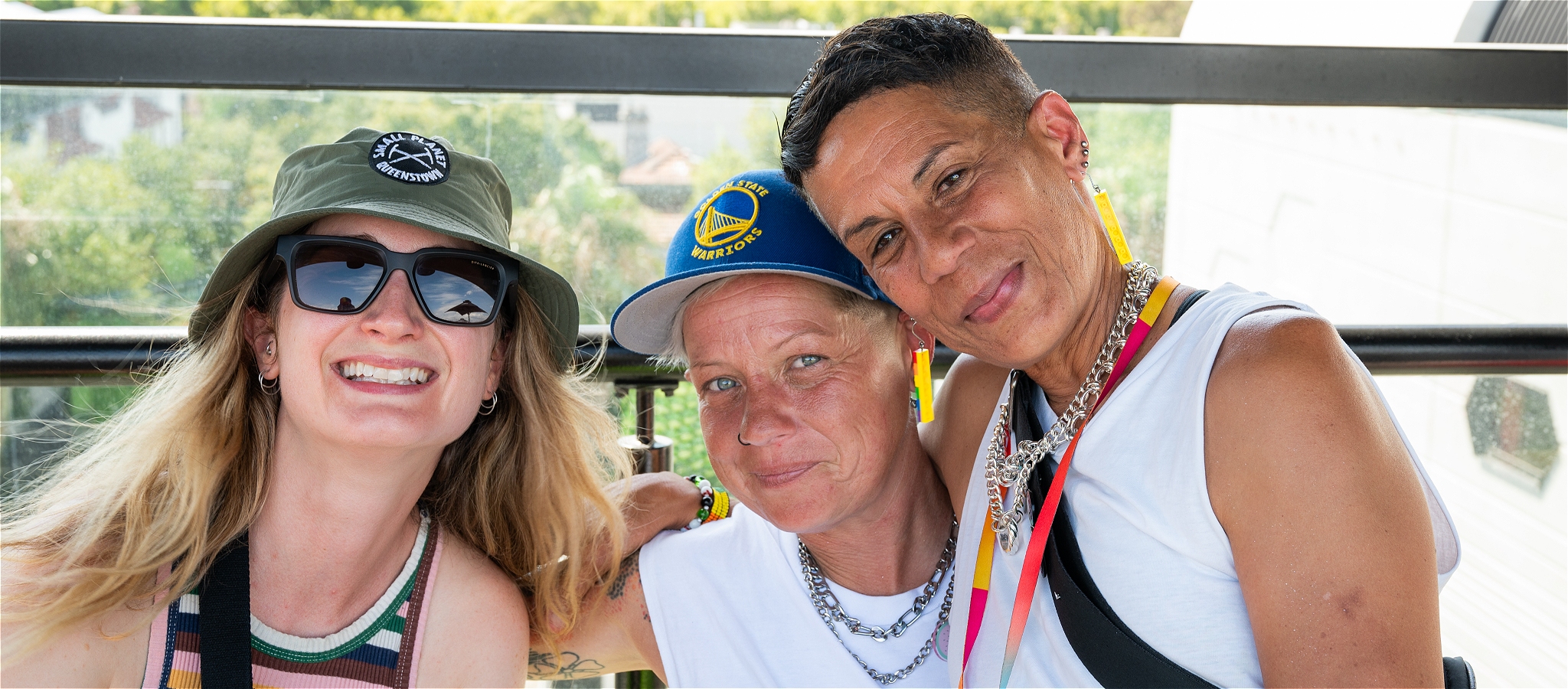 Three people smiling into the camera
