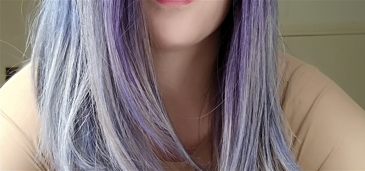 Photo of the neck of a person with long, mauve hair