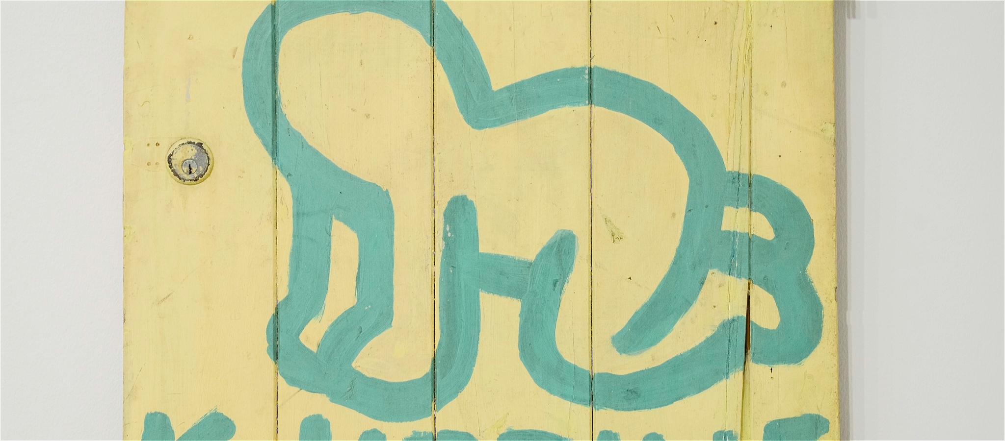 A painted blue outline of a figure on its hands and knees against a yellow background
