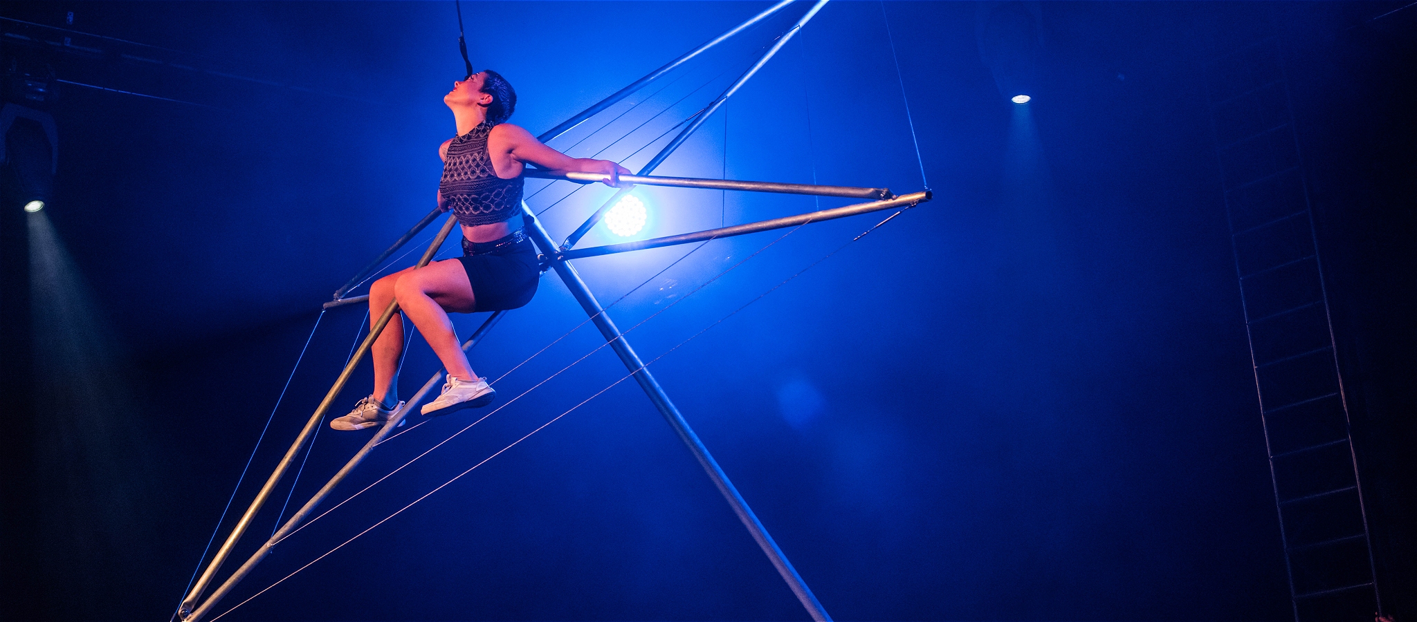 Acrobat balancing on a Hills Hoist