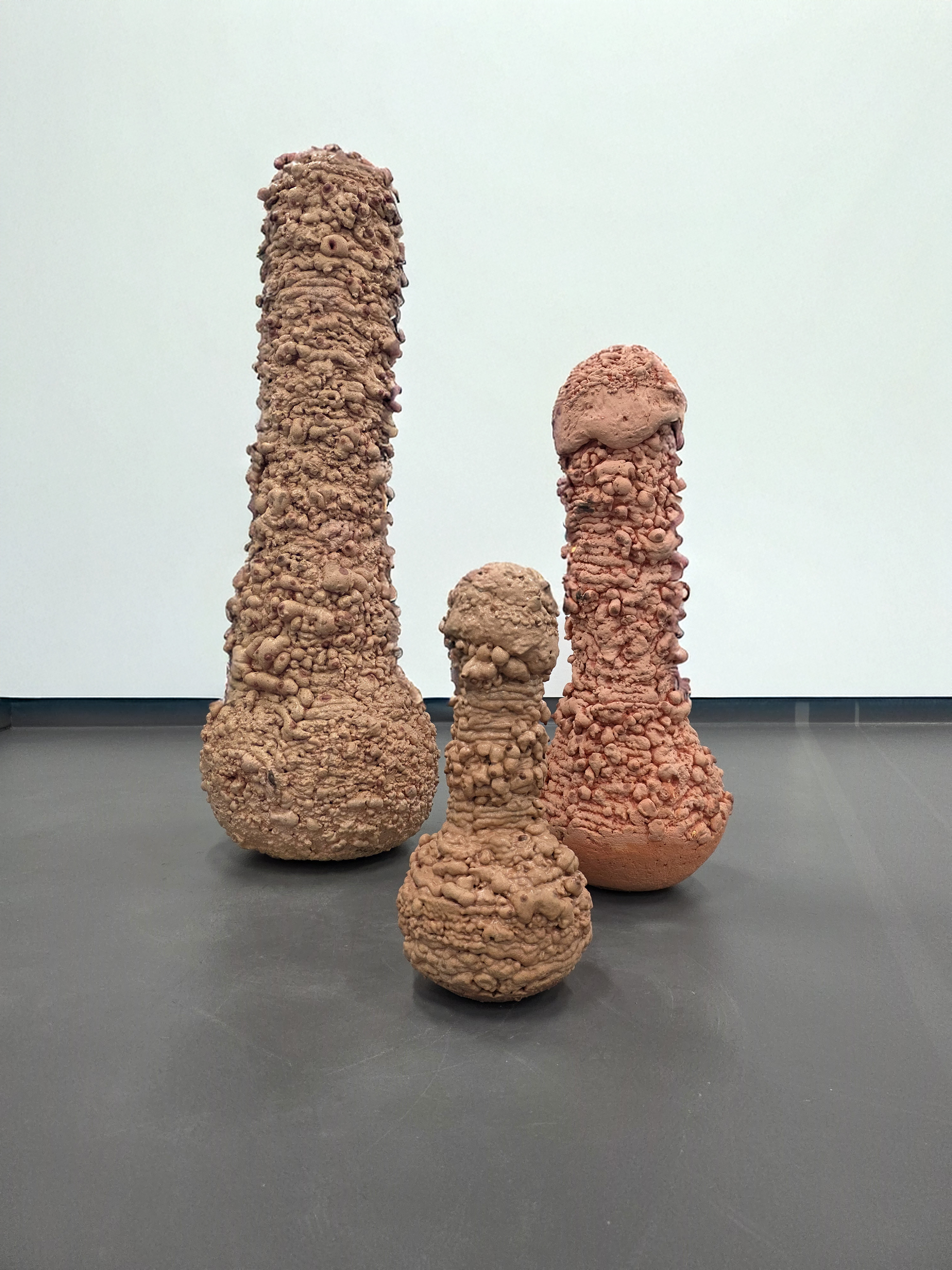 Three massive penis-like shapes each with a rounded base