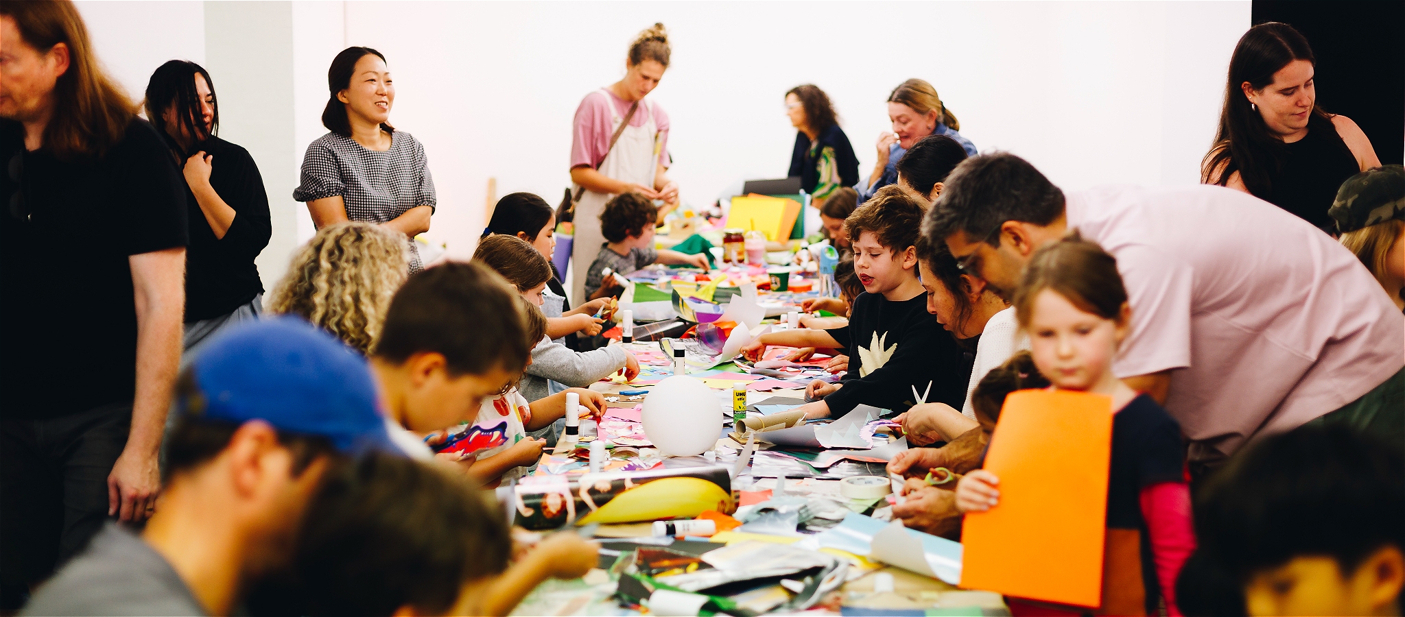 Kids sitting at a table doing crafts