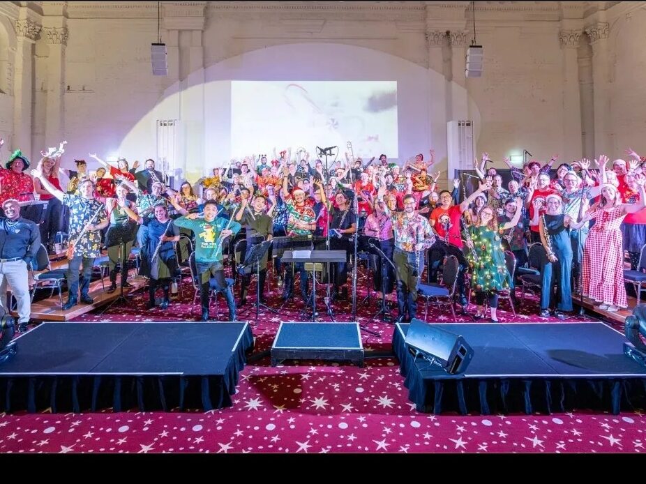 The rainbow band in a large, old hall with large podiums in the foreground