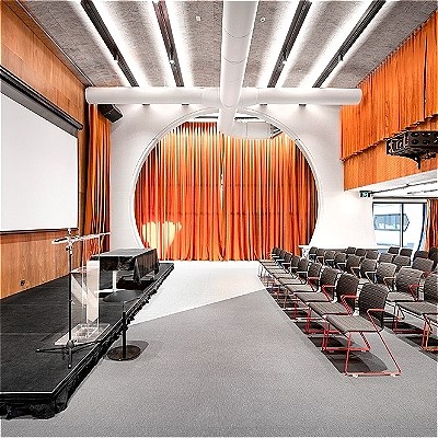 End-on seating facing a stage with a projector behind