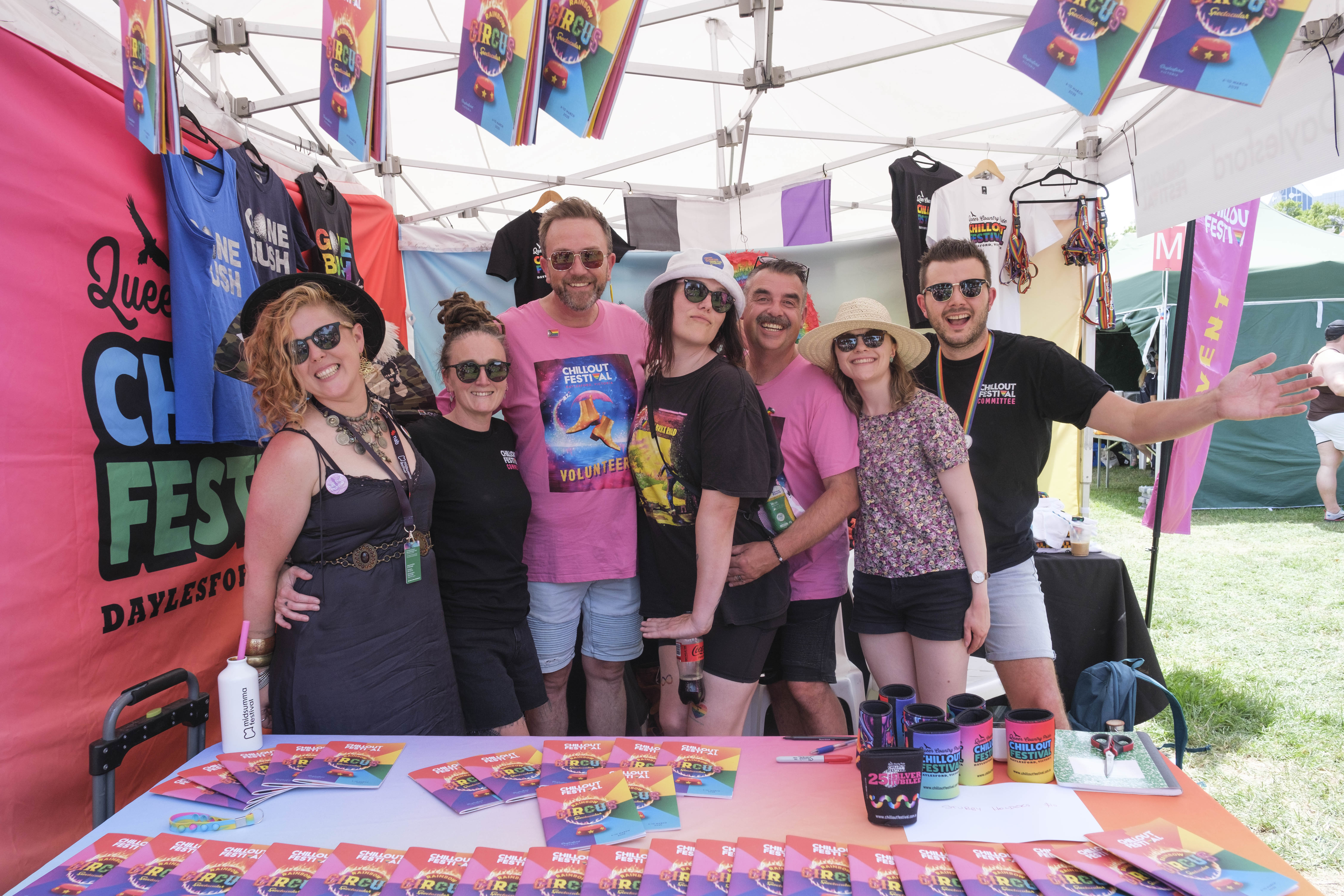 A stall at midsumma carnival 2025, with a bunch of very fabulous & happy people.