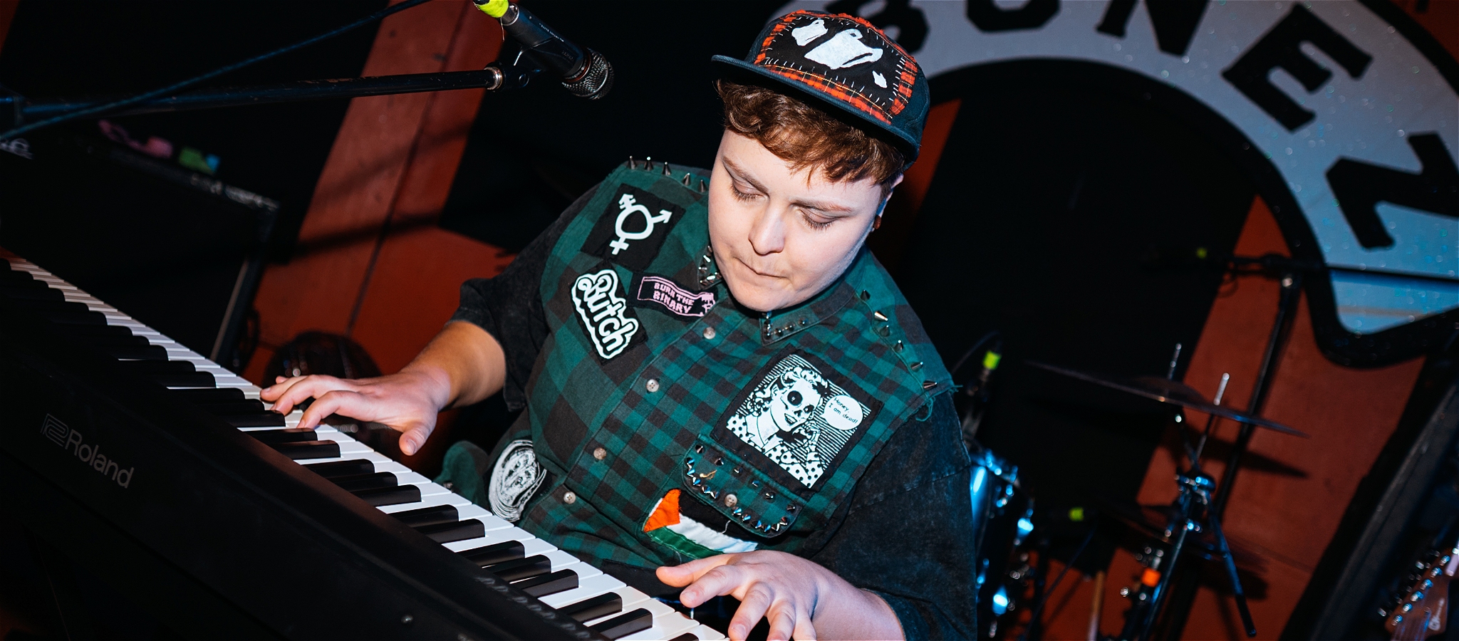 A young person looking intently at the keyboard as they are playing a piano