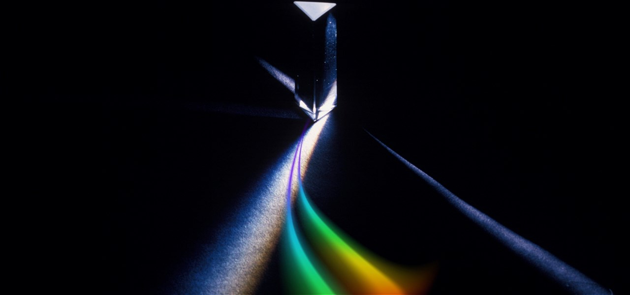 A rainbow prism of light on a black background