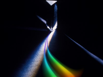 A rainbow prism of light on a black background