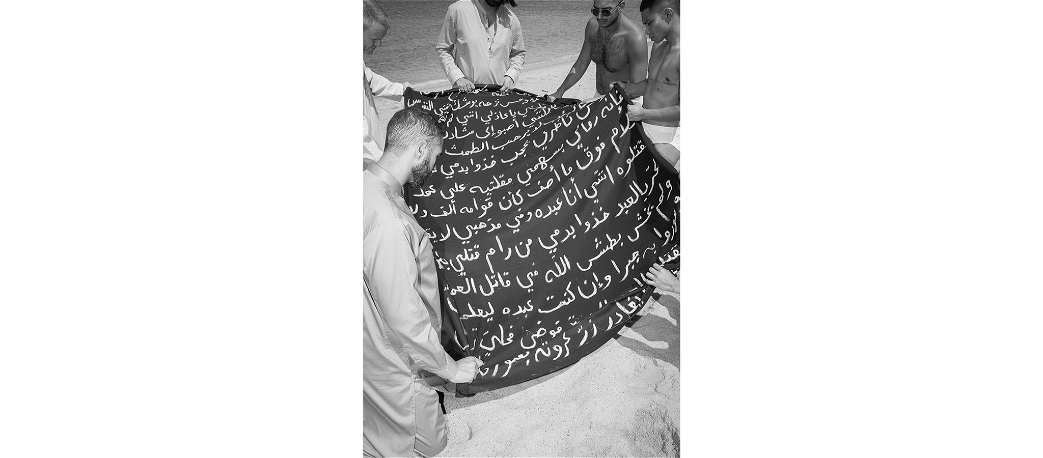 A photograph of people holding a black shroud, covered in white text.