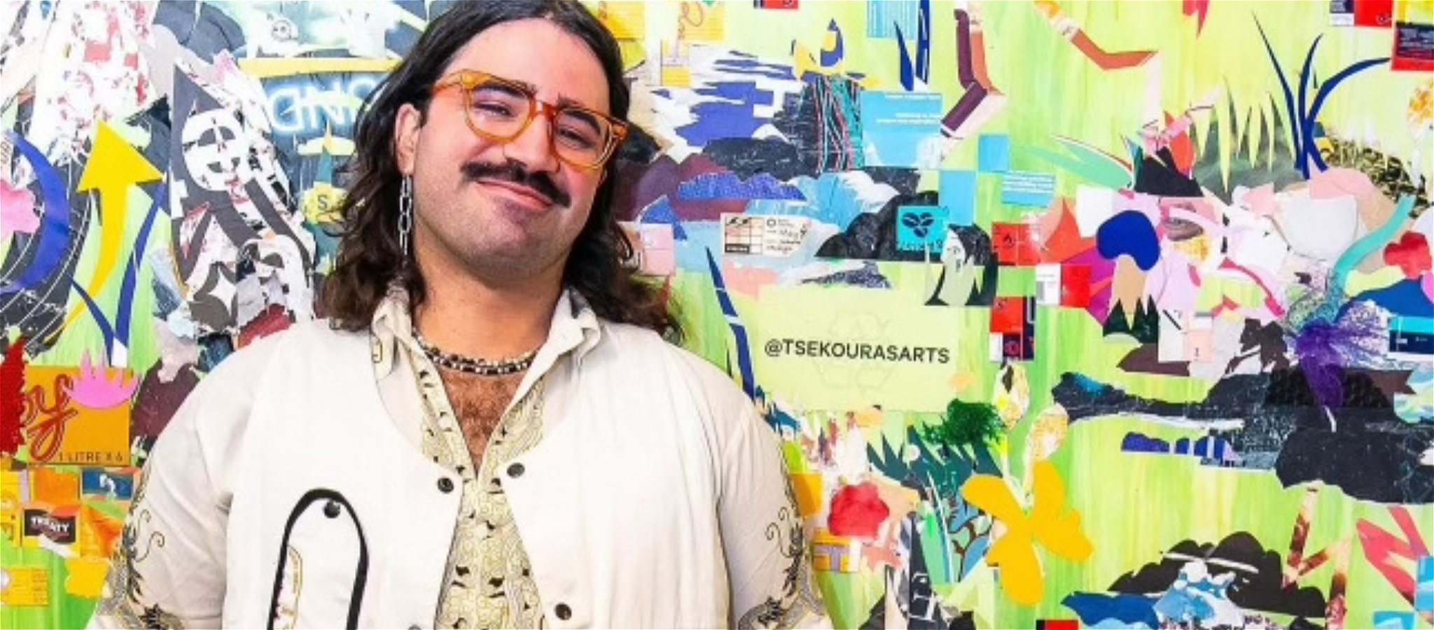 Nicky Tsekouras with long brown hair and a beard smiling at the camera wearing a white shirt and orange glasses against a collage background.