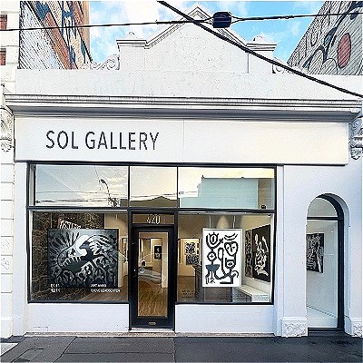 Exterior of the SOL GALLERY with lots of art works visible inside
