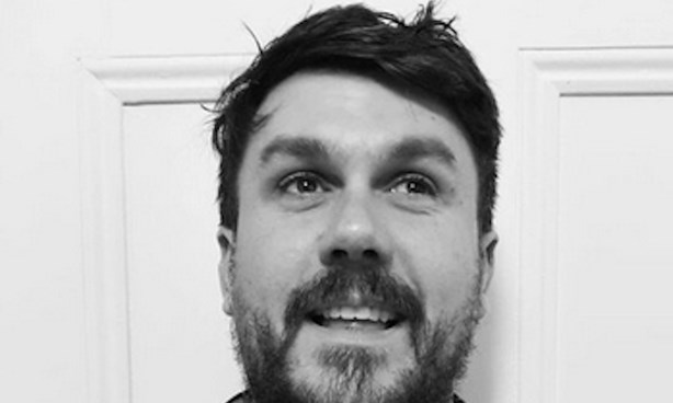 Black and white headshot of a bearded James Hale