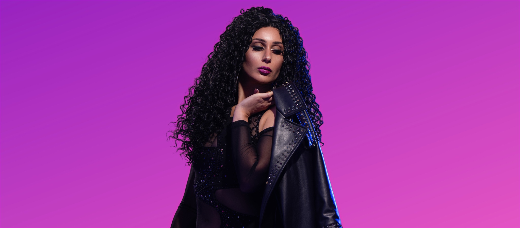Madeliene Axiak as Cher posing in front of purple background