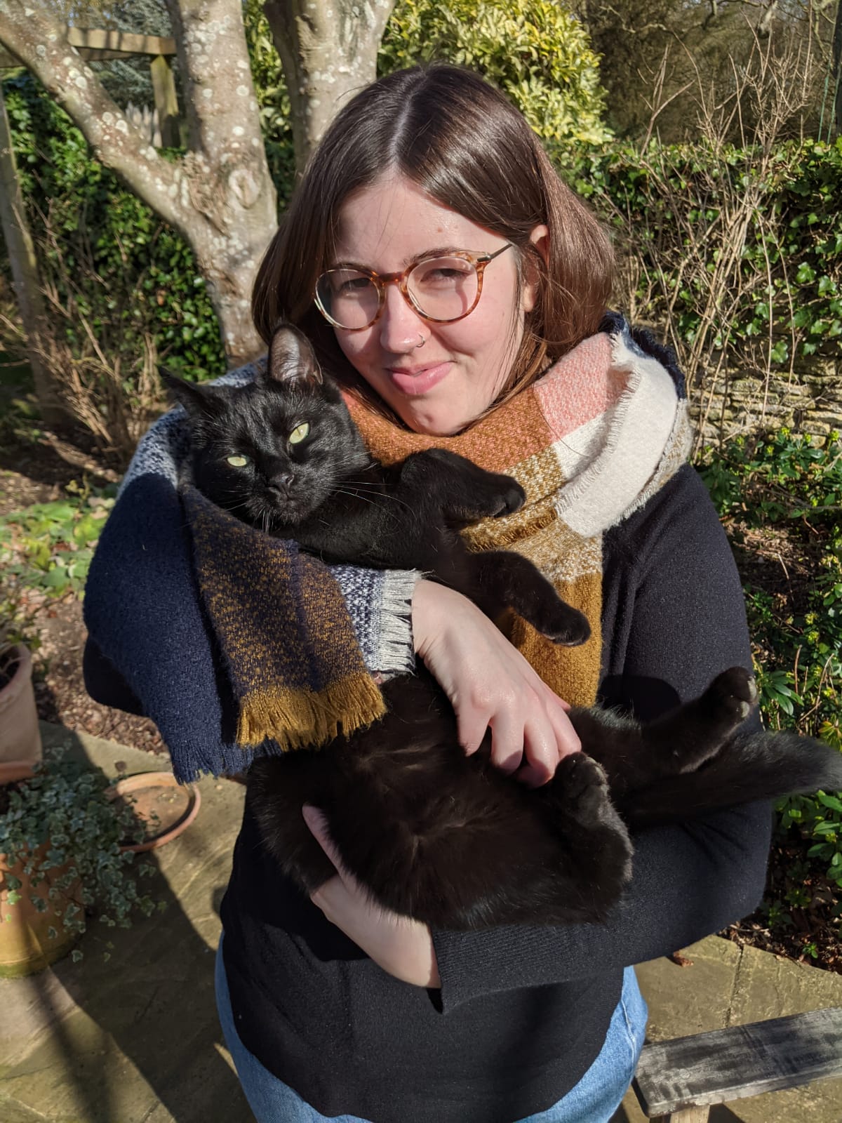 Emily Holland holding a black cat